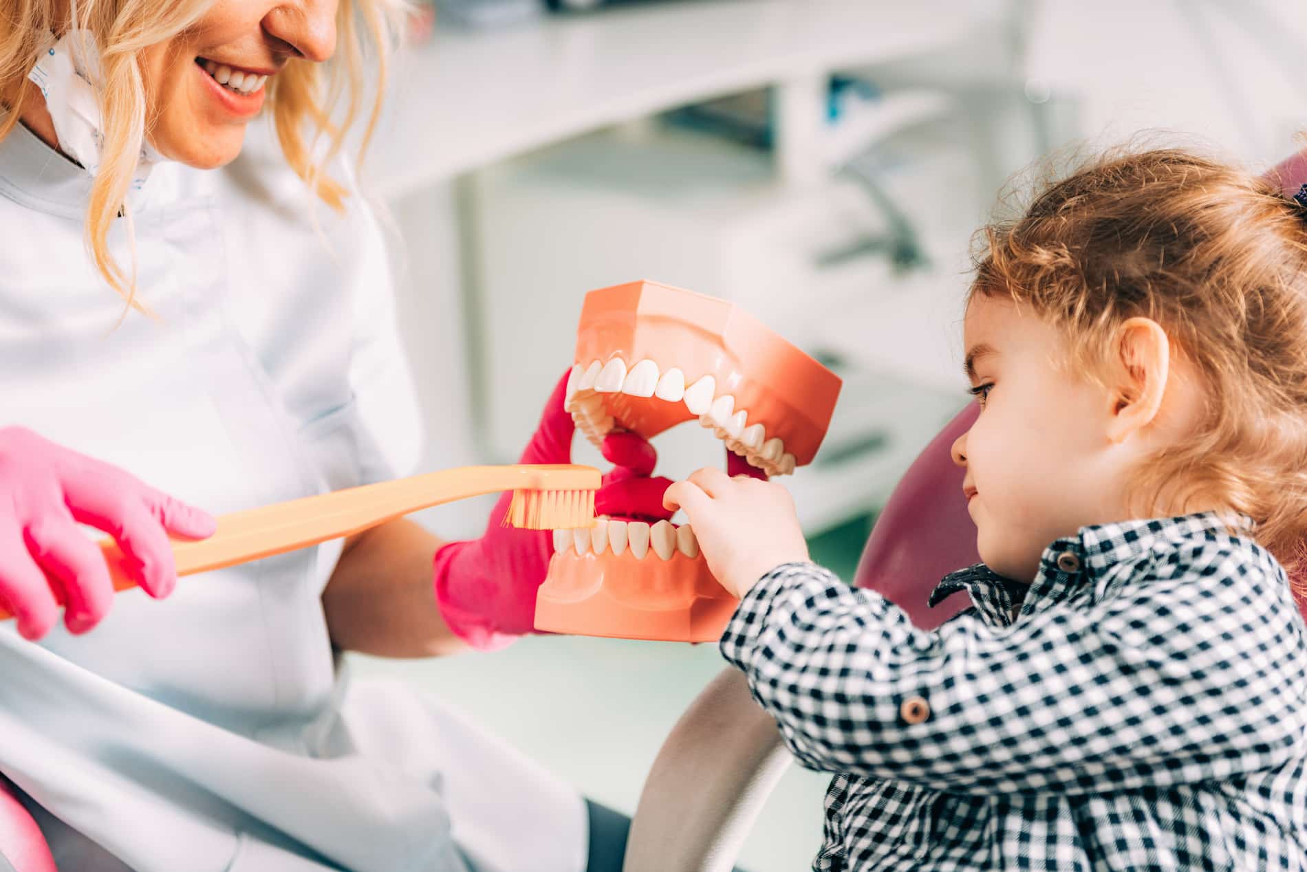 Girl gets her teeth cleaned by Dr. Kritika